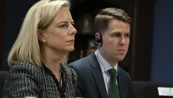 This March 27, 2018, provided by the Department of Homeland Security, then-Secretary of Homeland Security Kirstjen Nielsen and then-Department of Homeland Security chief of staff Miles Taylor, right, meet with Honduran President Juan Hernandez, not pictured, and security ministers from the Northern Triangle countries in Tegucigalpa, Honduras - Sputnik International