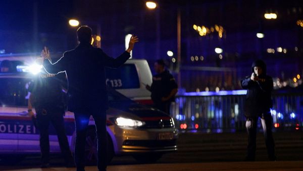 Police officers check a man on a street after exchanges of gunfire in Vienna, Austria November 2, 2020 - Sputnik International