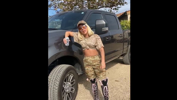 Screenshot from the video showing Lady Gaga leaning on a pickup truck with a can of beer while urging the followers to vote in US presidential election - Sputnik International