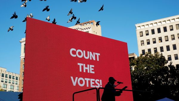 A person speaks on a stage as labor union activists rally at a park near the White House the day after the 2020 U.S. presidential election in Washington, U.S. November 4, 2020 - Sputnik International