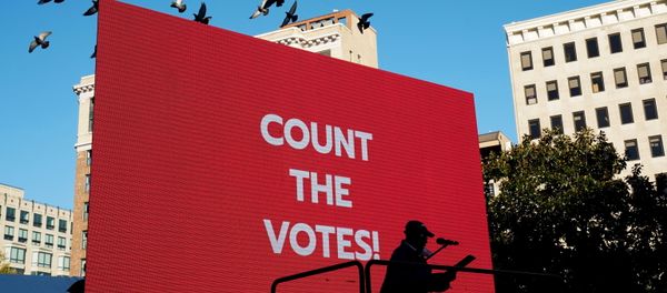 A person speaks on a stage as labor union activists rally at a park near the White House the day after the 2020 U.S. presidential election in Washington, U.S. November 4, 2020 - Sputnik International