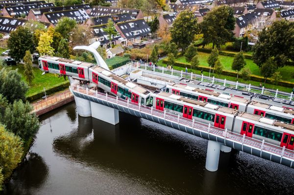 A photo taken in Spijkenisse, on 2 November 2020 of a Dutch metro train that was saved from disaster  when it smashed through a safety barrier but was prevented from plummeting into the water by a sculpture of a whale tail. The driver of the train, who was the only person on board, was unharmed in the incident, which happened just after midnight at Spijkenisse, near the port city of Rotterdam.  The front carriage was left hanging 10 metres (30 feet) above the water, propped up only by the giant silver-coloured sculpture -- called, improbably, Saved by the Whale's Tail.  - Sputnik International