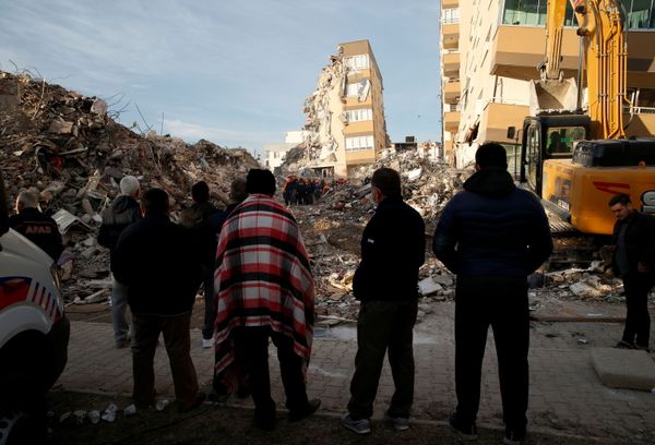 People watch as rescue operations take place in the coastal province of Izmir, Turkey on 3 November 2020 after an earthquake struck the Aegean Sea.  - Sputnik International