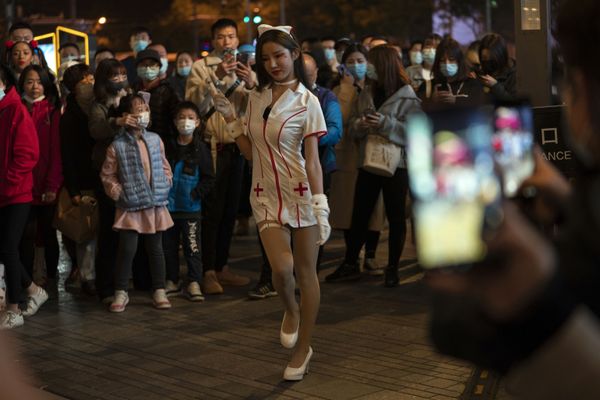 A young woman dressed as a nurse struts in a crowd gathered during Halloween night at a shopping district in Beijing on Saturday, 31 October 2020. Although Halloween is not traditionally celebrated in China, some residents in the Chinese capital took the time to dress up for a bit of fun.  - Sputnik International