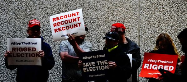 Supporters of U.S. President Donald Trump hold placards at a Stop the Steal protest outside Milwaukee Central Count the day after all of Milwaukee County’s absentee ballots were counted, in Milwaukee, Wisconsin, U.S. November 5, 2020. - Sputnik International