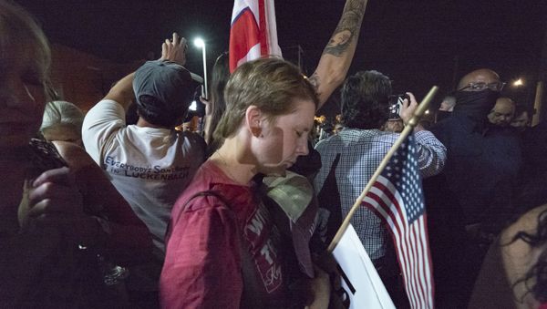 A woman seems to pray within a group of Trump supporters gathered in front of the Maricopa County Election Department where ballots are counted after the US presidential election in Phoenix, Arizona, on November 5, 2020. - Sputnik International