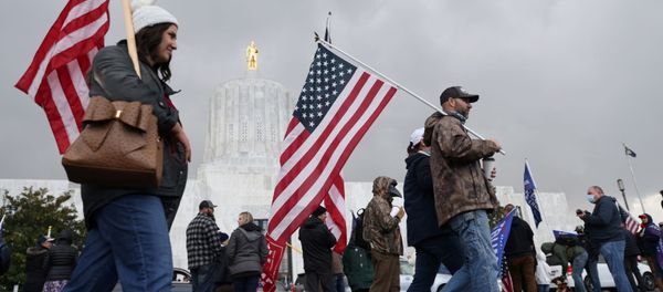 Supporters of U.S President Donald Trump carry U.S. flags during a protest after media announced that Democratic presidential nominee Joe Biden has won the election, in Salem, Oregon Supporters of U.S President Donald Trump carry U.S. flags during a protest after media announced that Democratic presidential nominee Joe Biden has won the election, in Salem, Oregon - Sputnik International