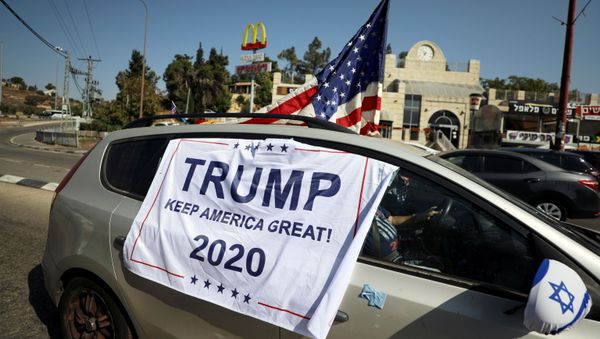 An American flag and banner cover a car, part of a convoy to the U.S. Embassy in Jerusalem to show support for U.S. President Donald Trump, ahead of the upcoming U.S. election, near Sho'eva, Israel October 27, 2020. REUTERS/Ammar Awad/File Photo An American flag and banner cover a car, part of a convoy to the U.S. Embassy in Jerusalem to show support for U.S. President Donald Trump, ahead of the upcoming U.S. election, near Sho'eva, Israel October 27, 2020. REUTERS/Ammar Awad/File Photo - Sputnik International