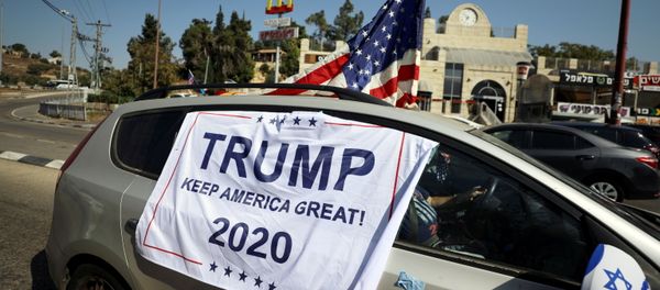 An American flag and banner cover a car, part of a convoy to the U.S. Embassy in Jerusalem to show support for U.S. President Donald Trump, ahead of the upcoming U.S. election, near Sho'eva, Israel October 27, 2020. REUTERS/Ammar Awad/File Photo An American flag and banner cover a car, part of a convoy to the U.S. Embassy in Jerusalem to show support for U.S. President Donald Trump, ahead of the upcoming U.S. election, near Sho'eva, Israel October 27, 2020. REUTERS/Ammar Awad/File Photo - Sputnik International