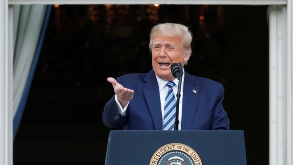 U.S. President Donald Trump stands on a White House balcony speaking to supporters gathered on the South Lawn for a campaign rally that the White House is calling a peaceful protest in Washington, U.S., October 10, 2020. - Sputnik International