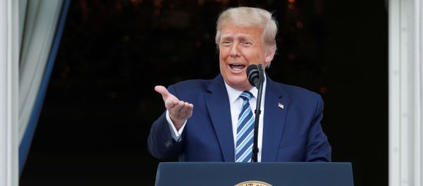 U.S. President Donald Trump stands on a White House balcony speaking to supporters gathered on the South Lawn for a campaign rally that the White House is calling a peaceful protest in Washington, U.S., October 10, 2020. - Sputnik International