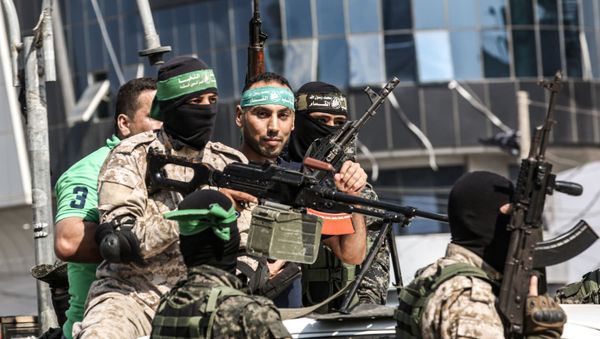 Abdel Halim Badawi (C), a Palestinian who was held for 18 years in an Israeli prison after he was convicted of being a member of Hamas' armed wing in 2001, rides in the back of a pickup truck with Hamas militants as they celebrate his release in Rafah in the southern Gaza Strip on October 17, 2019 - Sputnik International