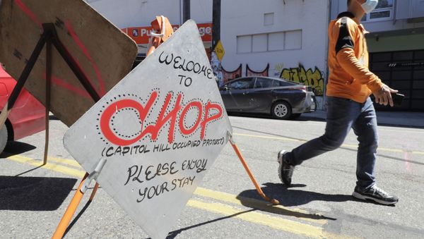 A sign welcomes visitors Monday, June 22, 2020, near an entrance to what has been named the Capitol Hill Occupied Protest zone in Seattle. For the second time in less than 48 hours, there was a shooting near the CHOP area that has been occupied by protesters after Seattle Police pulled back from several blocks of the city's Capitol Hill neighborhood near the Police Department's East Precinct building - Sputnik International