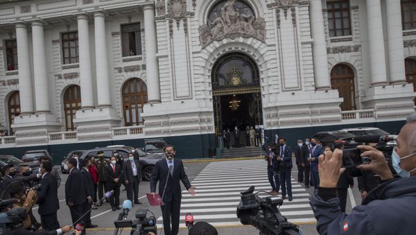 Peruvian President Martin Vizcarra talks to reporters before entering Congress where he faces an impeachment vote in Lima, Peru, Monday, Nov. 9, 2020. - Sputnik International