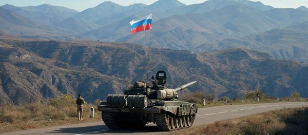 A service member of the Russian peacekeeping troops walks near a tank near the border with Armenia, following the signing of a deal to end the military conflict between Azerbaijan and ethnic Armenian forces, in the region of Nagorno-Karabakh, November 10, 2020. A service member of the Russian peacekeeping troops walks near a tank near the border with Armenia, following the signing of a deal to end the military conflict between Azerbaijan and ethnic Armenian forces, in the region of Nagorno-Karabakh, November 10, 2020. - Sputnik International