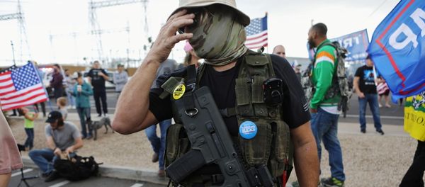 A Trump supporter carries a semi-automatic rifle at a Stop the Steal protest after the 2020 U.S. presidential election was called for Democratic candidate Joe Biden, in front of the Maricopa County Tabulation and Election Center (MCTEC), in Phoenix, Arizona, U.S., November 7, 2020 A Trump supporter carries a semi-automatic rifle at a Stop the Steal protest after the 2020 U.S. presidential election was called for Democratic candidate Joe Biden, in front of the Maricopa County Tabulation and Election Center (MCTEC), in Phoenix, Arizona, U.S., November 7, 2020 - Sputnik International