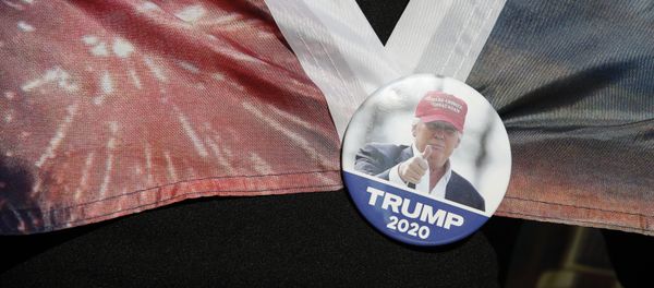 A woman wears a Trump button as supporters of President Donald Trump protest outside the Pennsylvania Convention Center, where vote counting continues, in Philadelphia, Monday, Nov. 9, 2020 A woman wears a Trump button as supporters of President Donald Trump protest outside the Pennsylvania Convention Center, where vote counting continues, in Philadelphia, Monday, Nov. 9, 2020 - Sputnik International