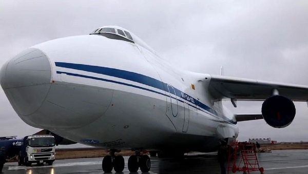 In this handout video grab released by the Russian Defense Ministry, a transport plane stands on the runway while a helicopter is loaded into it, at an airport in Moscow region, Russia - Sputnik International