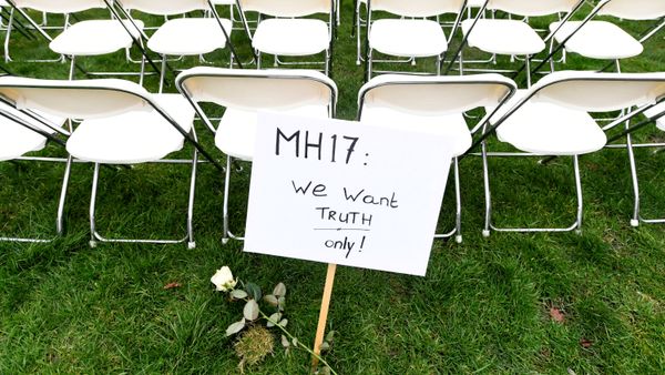 FILE PHOTO: A protest sign stands in front of a row of chairs as family members of victims of the MH17 crash lined up empty chairs for each seat on the plane during a protest outside the Russian Embassy in The Hague, Netherlands 8 March 2020. - Sputnik International