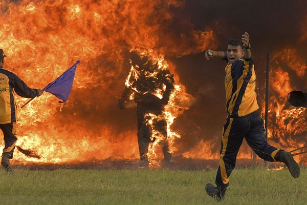 Daredevil motorcyclist Captain Shivam Singh (C) from the Tornadoes motorcycle acrobatic team of the Indian Armed Forces comes out ablaze after catching fire while riding his bike through a tunnel of fire during an attempt to break the Guinness Book of World Records in Bangalore on 10 November 2020. Daredevil motorcyclist Captain Shivam Singh (C) from the Tornadoes motorcycle acrobatic team of the Indian Armed Forces comes out ablaze after catching fire while riding his bike through a tunnel of fire during an attempt to break the Guinness Book of World Records in Bangalore on 10 November 2020. - Sputnik International