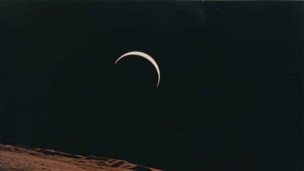 Crescent Earth rising beyond the Moon's barren horizon, 1971.  - Sputnik International