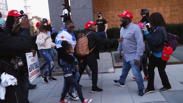 Supporters of U.S. President Donald Trump try to stop a fellow supporter from engaging as they walk past anti-Trump protesters, after the 2020 U.S. presidential election was called for Democratic candidate Joe Biden, in Washington, U.S. November 14, 2020. - Sputnik International