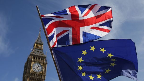 In this file picture, taken on 25 March 2017, an EU flag and a Union flag held by a demonstrator is seen with Elizabeth Tower (Big Ben) and the Houses of Parliament as marchers taking part in an anti-Brexit, pro-European Union (EU) enter Parliament Square in central London. In this file picture, taken on 25 March 2017, an EU flag and a Union flag held by a demonstrator is seen with Elizabeth Tower (Big Ben) and the Houses of Parliament as marchers taking part in an anti-Brexit, pro-European Union (EU) enter Parliament Square in central London. - Sputnik International