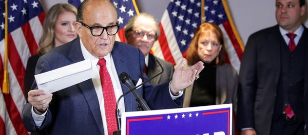 Former New York City Mayor Rudy Giuliani, personal attorney to US President Donald Trump, holds what he identified as a replica mail-in ballot as he speaks about the 2020 US presidential election results during a news conference in Washington, US, 19 November 2020. REUTERS/Jonathan Ernst. - Sputnik International