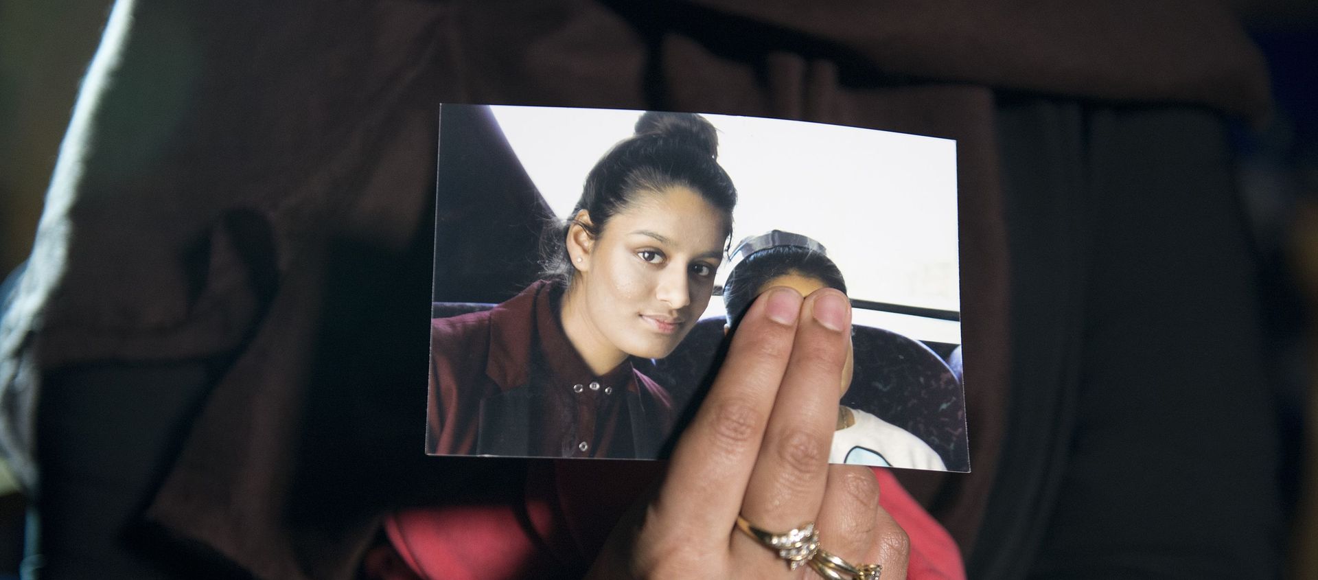 Renu, eldest sister of missing British girl Shamima Begum, holds a picture of her sister while being interviewed by the media in central London, on February 22, 2015. Britain debated Sunday how to stop teenage girls joining the Islamic State group in Syria after three high-achieving youngsters became the latest to run away from home. Close schoolfriends Kadiza Sultana, 17, and 15-year-olds Shamima Begum and Amira Abase left their east London homes on Tuesday and flew to Istanbul, raising concerns they would travel on to Syria to join IS jihadists. Renu, eldest sister of missing British girl Shamima Begum, holds a picture of her sister while being interviewed by the media in central London, on February 22, 2015. Britain debated Sunday how to stop teenage girls joining the Islamic State group in Syria after three high-achieving youngsters became the latest to run away from home. Close schoolfriends Kadiza Sultana, 17, and 15-year-olds Shamima Begum and Amira Abase left their east London homes on Tuesday and flew to Istanbul, raising concerns they would travel on to Syria to join IS jihadists. - Sputnik International, 1920, 15.12.2020
