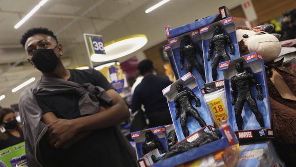 A demonstrator stands next to Black Panther action figures used to block a cashier counter of a Carrefour supermarket during a protest against racism, after Joao Alberto Silveira Freitas was beaten to death by security guards at a Carrefour supermarket in Porto Alegre, in Rio de Janeiro, Brazil, 20 November 2020. - Sputnik International
