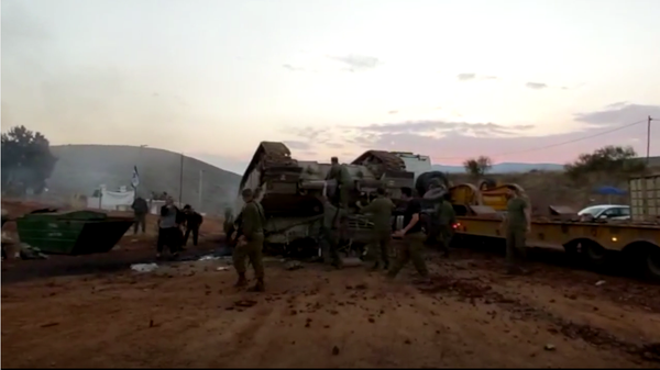 A screenshot from the social media video showing the Israeli Merkava tank flipped over the carrier, 22 November 2020 - Sputnik International