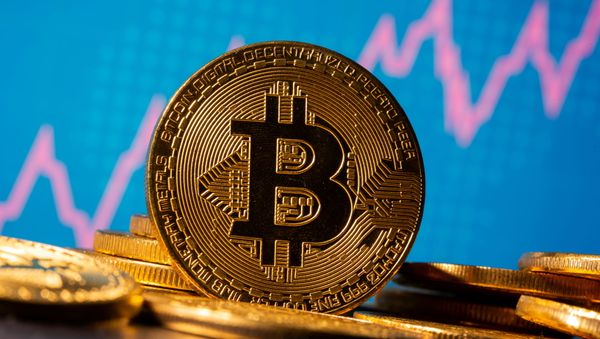A representation of virtual currency Bitcoin is seen in front of a share graph in this illustration taken 19 November 2020. - Sputnik International