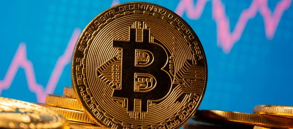 A representation of virtual currency Bitcoin is seen in front of a share graph in this illustration taken 19 November 2020. - Sputnik International