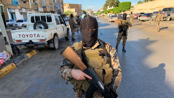 A member of the Libyan security forces holds a rifle as they are deployed in Misrata, Libya November 19, 2020 - Sputnik International