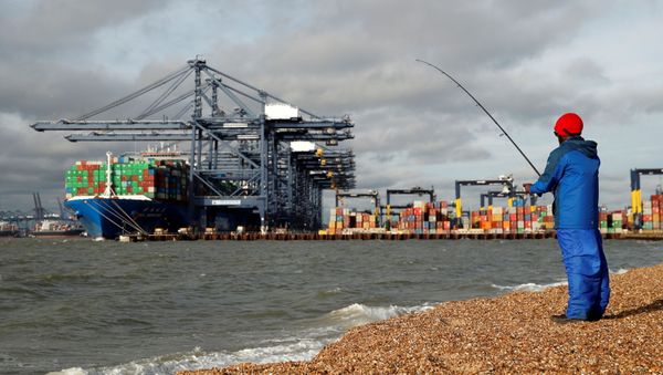 The CSCL Mercury and containers are seen at The Port of Felixstowe as a man fishes, in Felixstowe, Britain, November 17, 2020.   - Sputnik International