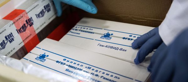 In this handout photo released by Hungarian Foreign Ministry, laboratory assistants unpack Russia's coronavirus vaccine Gam-COVID-Vac, trade-named Sputnik V, in Budapest, Hungary - Sputnik International