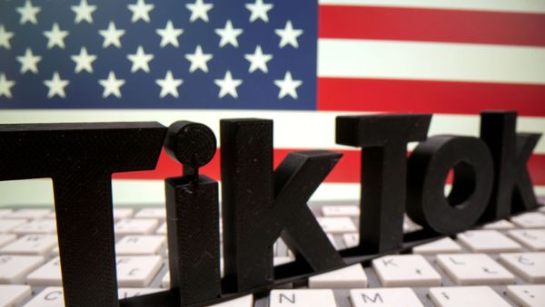 A 3D printed TikTok logo is placed on a keyboard in front of U.S. flag in this illustration taken October 6, 2020. - Sputnik International