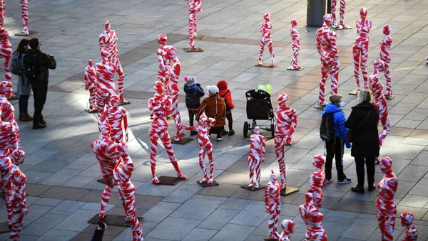 People stand in-between an art installation with 111 mannequins on Marienplatz calling for more mindfulness and appreciation in times of corona as the spread of the coronavirus disease (COVID-19) continues in Munich, Germany, November 18, 2020 - Sputnik International