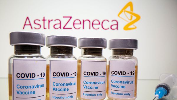 Vials with a sticker reading, COVID-19 / Coronavirus vaccine / Injection only and a medical syringe are seen in front of a displayed AstraZeneca logo in this illustration taken October 31, 2020. Vials with a sticker reading, COVID-19 / Coronavirus vaccine / Injection only and a medical syringe are seen in front of a displayed AstraZeneca logo in this illustration taken October 31, 2020. - Sputnik International