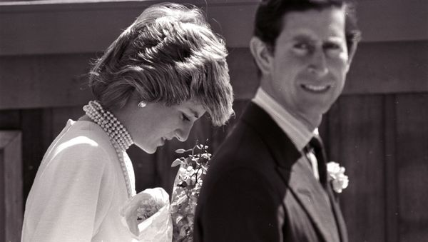 Princess Diana bows her head following Prince Charles on a walk to the California Pavilion in Vancouver May 6, 1986 - Sputnik International