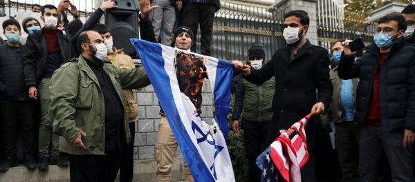 Protesters burn the U.S. and Israeli flags during a demonstration against the the killing of Mohsen Fakhrizadeh, Iran's top nuclear scientist, in Tehran, Iran, November 28, 2020.  - Sputnik International