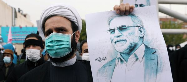 A protester holds a picture of Mohsen Fakhrizadeh, Iran's top nuclear scientist, during a demonstration against his killing in Tehran, Iran, November 28, 2020 - Sputnik International
