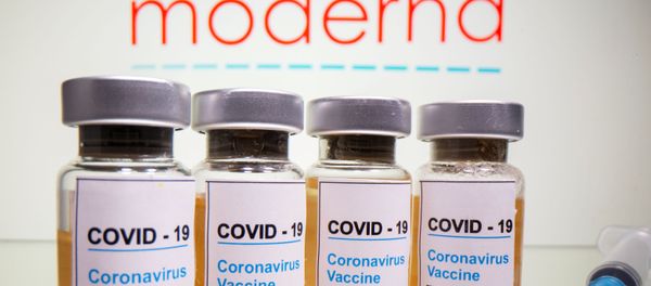Vials with a sticker reading, COVID-19 / Coronavirus vaccine / Injection only and a medical syringe are seen in front of a displayed Moderna logo in this illustration taken October 31, 2020. Vials with a sticker reading, COVID-19 / Coronavirus vaccine / Injection only and a medical syringe are seen in front of a displayed Moderna logo in this illustration taken October 31, 2020. - Sputnik International