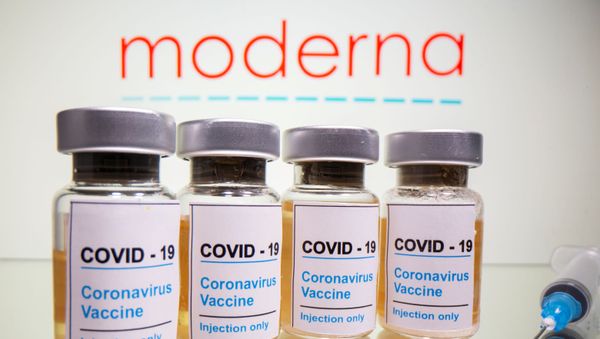 Vials with a sticker reading, COVID-19 / Coronavirus vaccine / Injection only and a medical syringe are seen in front of a displayed Moderna logo in this illustration taken October 31, 2020. Vials with a sticker reading, COVID-19 / Coronavirus vaccine / Injection only and a medical syringe are seen in front of a displayed Moderna logo in this illustration taken October 31, 2020. - Sputnik International