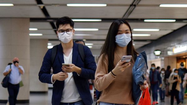 People wear masks following the coronavirus disease (COVID-19) outbreak, at the financial Central district in Hong Kong, China December 1, 2020 - Sputnik International