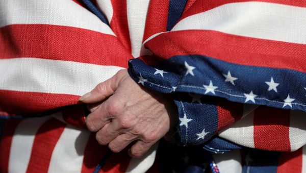 FILE PHOTO: A supporter of U.S. President Donald Trump wearing the colors of the U.S. flag participates in a Stop the Steal protest after the 2020 U.S. presidential election was called for Democratic candidate Joe Biden, in Lansing, Michigan, U.S. November 14, 2020.  - Sputnik International