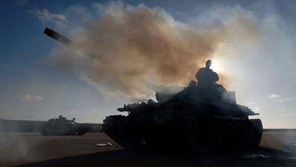 Members of Libyan National Army (LNA) commanded by Khalifa Haftar, get ready before heading out of Benghazi to reinforce the troops advancing to Tripoli, in Benghazi, Libya April 13, 2019. - Sputnik International