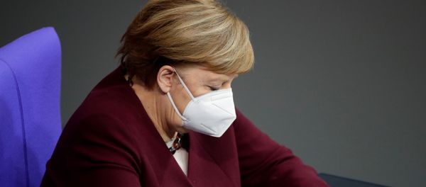 German Chancellor Angela Merkel wears a protective face mask after delivering a speech on the government's response to the coronavirus disease (COVID-19) pandemic in the country's parliament, the Bundestag, in Berlin, Germany, November 26, 2020. German Chancellor Angela Merkel wears a protective face mask after delivering a speech on the government's response to the coronavirus disease (COVID-19) pandemic in the country's parliament, the Bundestag, in Berlin, Germany, November 26, 2020. - Sputnik International