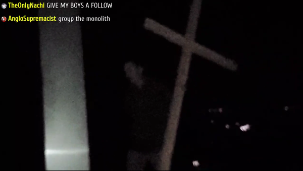 A screenshot from streaming video of an unknown group destroying the mysterious monolith structure on California's mountain top, 3 December 2020 - Sputnik International
