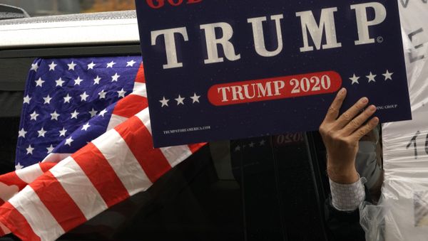 A demonstrator holds a sign out of his car window during a ‘MAGA May Day’ rally in Stream Valley, New York, on May 1, 2020 - Sputnik International